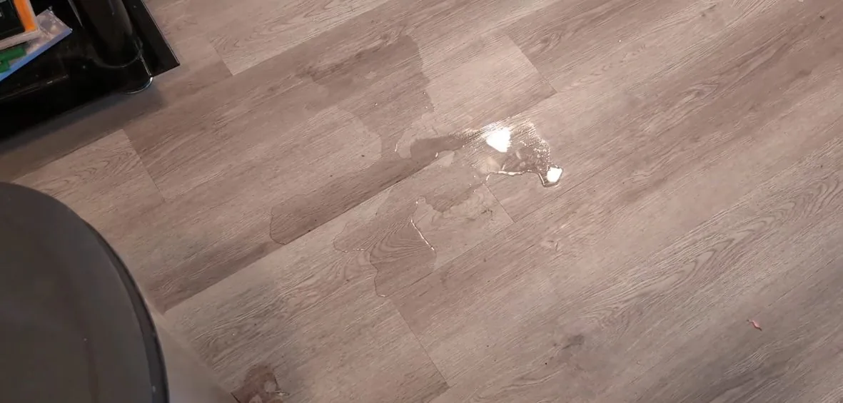 Drops of water on a gray vinyl plank floor